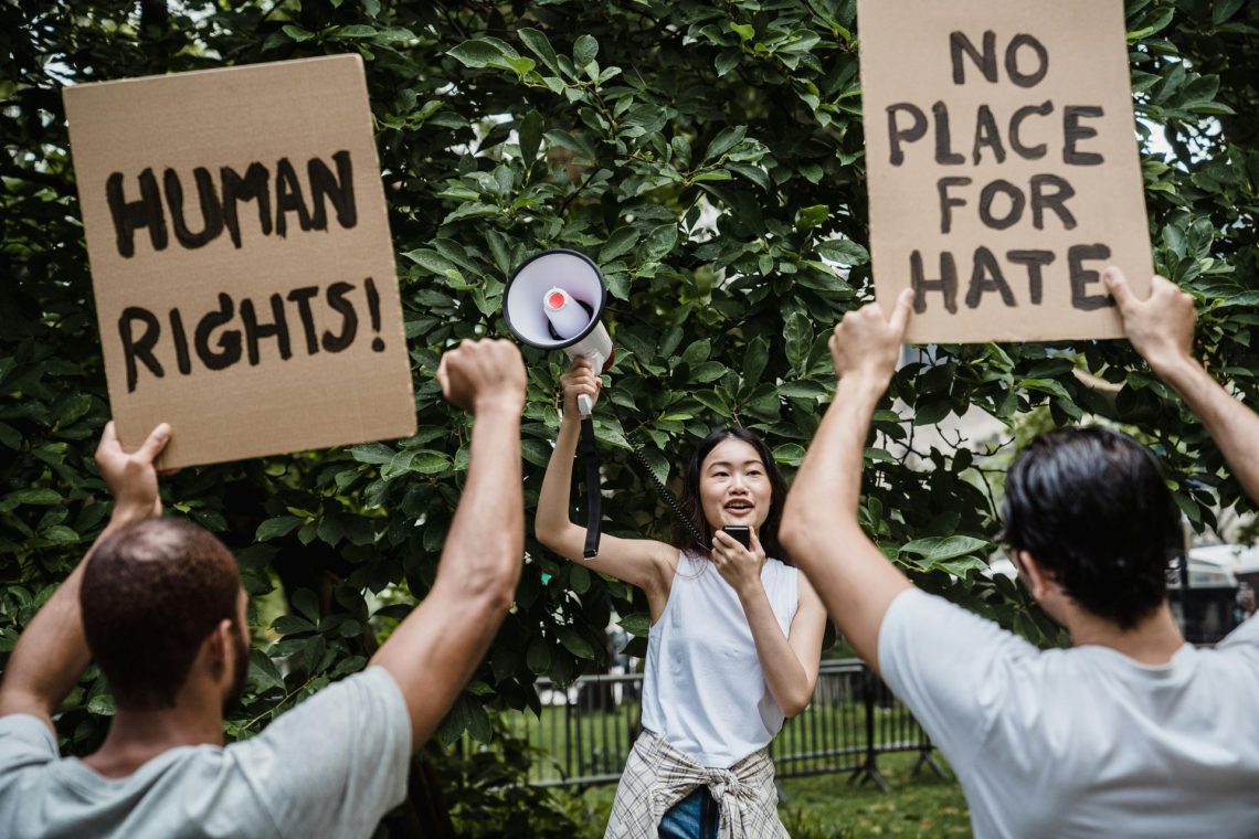 Human rights, no place for hate written on signs