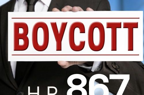 A man in a suit with a sign taht says boycott and under it says H.R 867